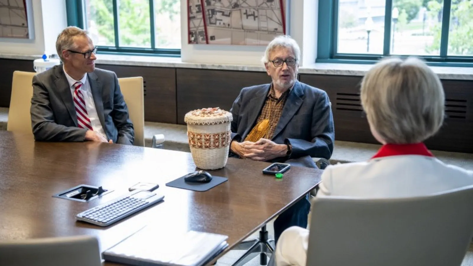 Three people are sitting at a table.